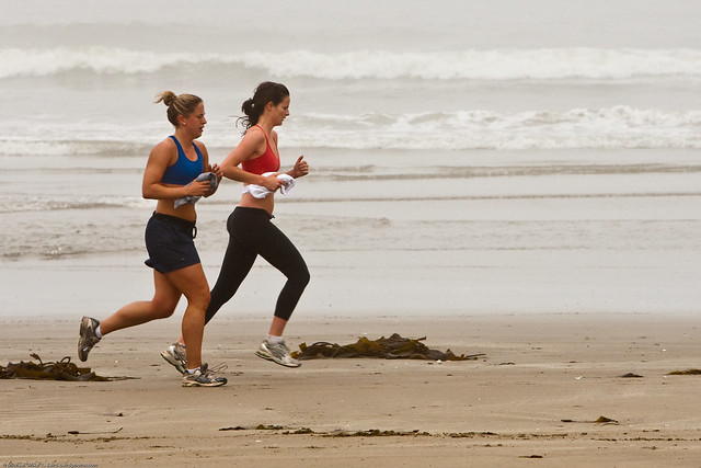 Two female joggers on foggy Morro Strand State Beach